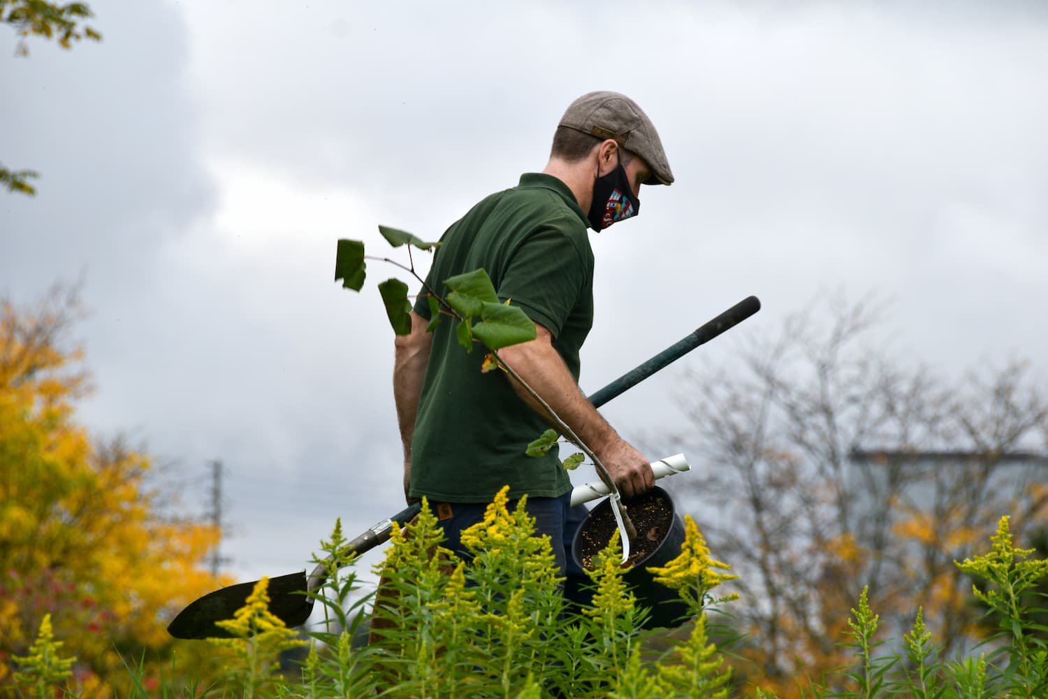 landscaper carrying tools